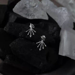 Close-up detail of the sparkling zircons and plating on the Rivet Jacket Earrings
