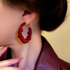 Model showcasing the dangle and style of the Silver Post Wrinkled Leather Earrings