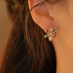 Model showcasing the dangle and style of the Silver Post Christmas Crystal Elk Snowflake Earrings