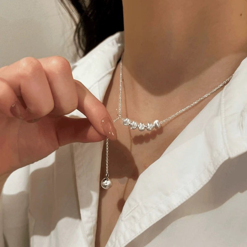 Detailed view of the Sterling Silver Adjustable Beads Tassel Necklace chain and pendant