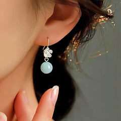 Model showcasing the dangle and style of the Sterling Silver Amazonite Flower Earrings