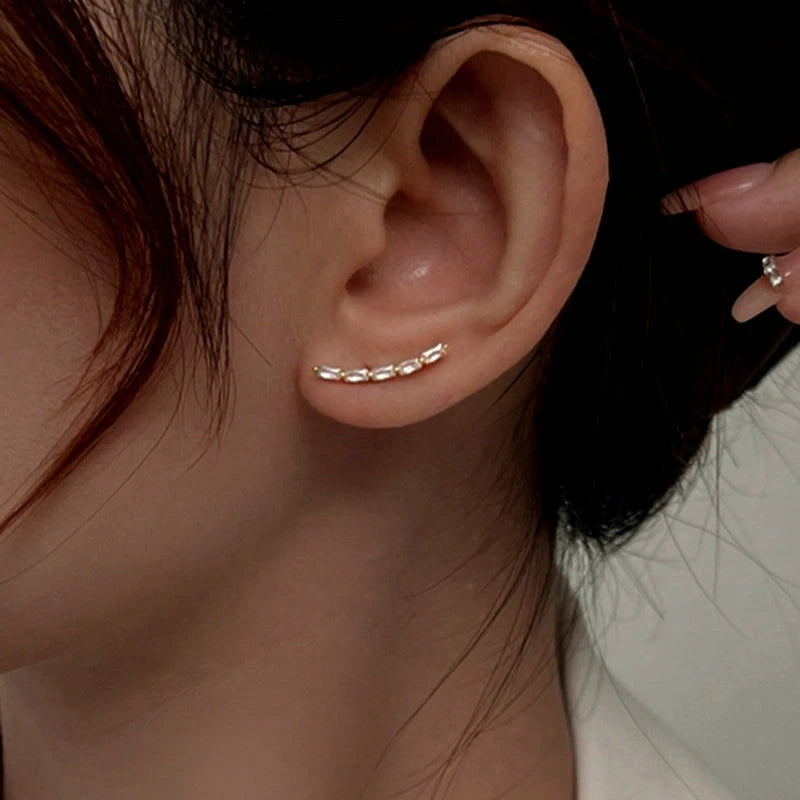 Model showcasing the dangle and style of the Sterling Silver Arc-Shaped Diamond Stud Earrings