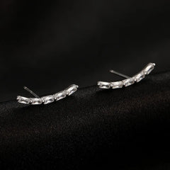Close-up detail of the sparkling zircons and plating on the Arc Stud Earrings