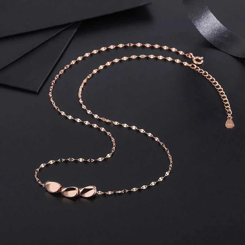 Close-up of the pendant and clasp on the Silver Bean Necklace