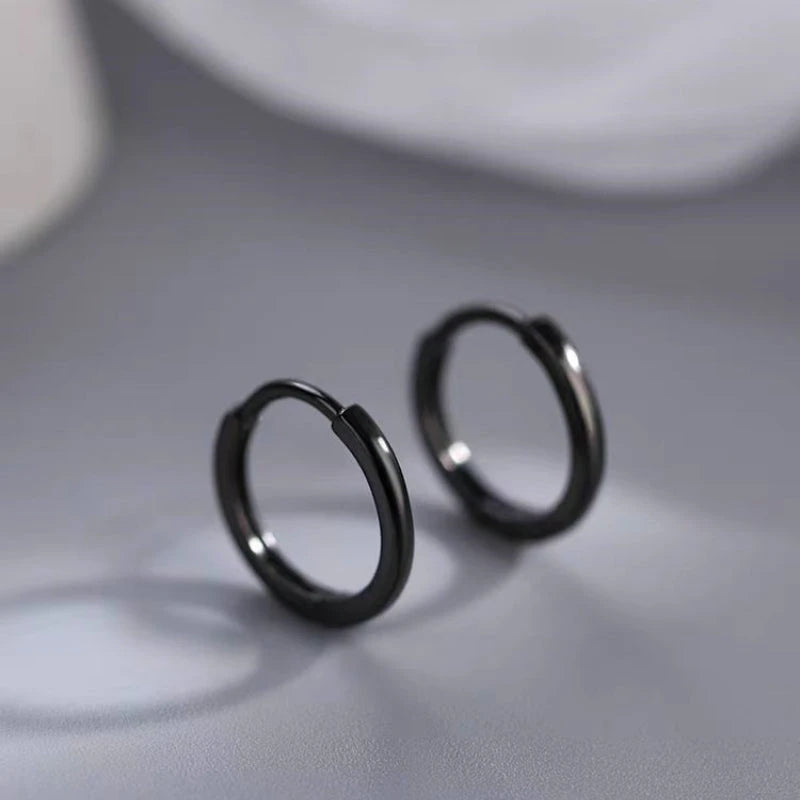 Model showcasing the dangle and style of the Sterling Silver Black Small Hoop Earrings