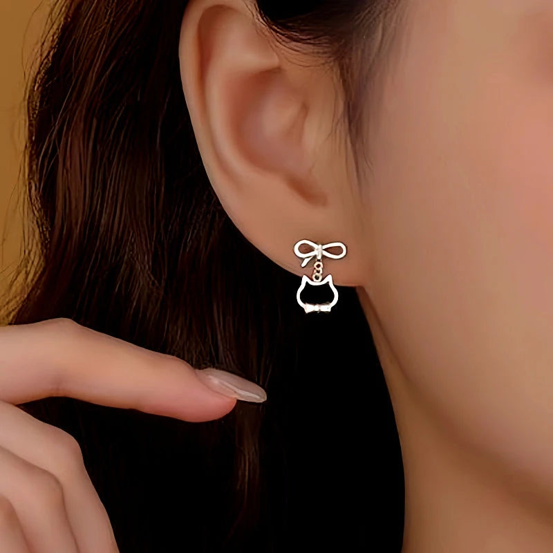 Model showcasing the dangle and style of the Sterling Silver Bow Cat Earrings