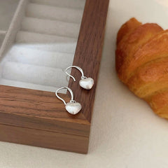 Close-up detail of the sparkling zircons and plating on the Frosted Heart Earrings