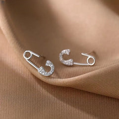 Close-up detail of the sparkling zircons and plating on the Buckle Stud Earrings