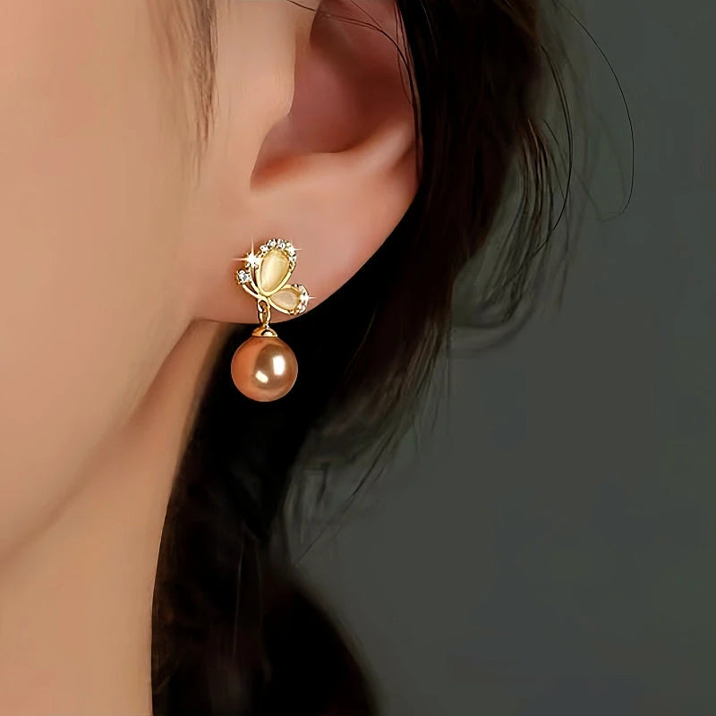 Close-up detail of the sparkling zircons and plating on the Butterfly Pearl Earrings