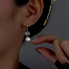 Model showcasing the dangle and style of the Sterling Silver Cat's Eye Stone Pearl Ear Hooks