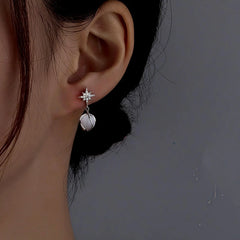 Angled view of the Sterling Silver Cat's Eye Stone Zircon Eight-Pointed Star Earrings