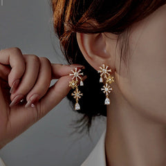Model showcasing the dangle and style of the Sterling Silver Christmas Diamond Snowflake Earrings