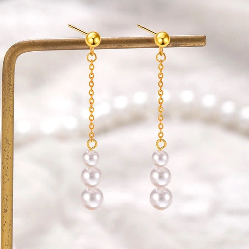 Angled view of the Sterling Silver Christmas Pearl Tassel Earrings