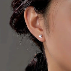 Model showcasing the dangle and style of the Sterling Silver Christmas Snowflake Bell Tassel Asymmetrical Earrings