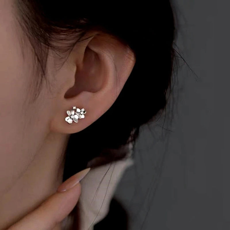 Model showcasing the dangle and style of the Sterling Silver Clover Stud Earrings