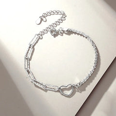 Model wearing the Sterling Silver Couple Star And Heart Bracelets to highlight its design on the wrist