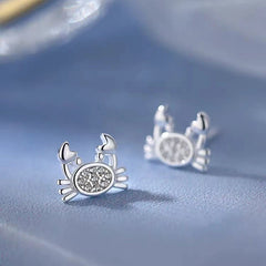 Close-up detail of the sparkling zircons and plating on the Crab Stud Earrings