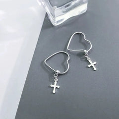 Close-up detail of the sparkling zircons and plating on the Cross Heart Earrings