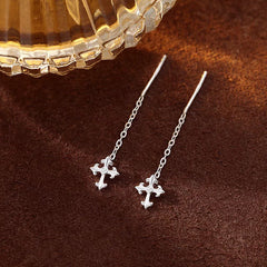 Angled view of the Sterling Silver Cross Tassel Threader Earrings