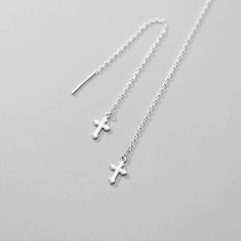Model showcasing the dangle and style of the Sterling Silver Cross Threader Earrings