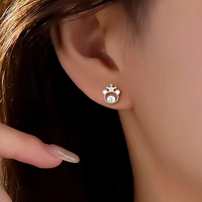 Model showcasing the dangle and style of the Sterling Silver Crown Bear Studs