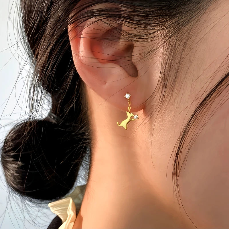 Model showcasing the dangle and style of the Sterling Silver Cute Kitten Earrings