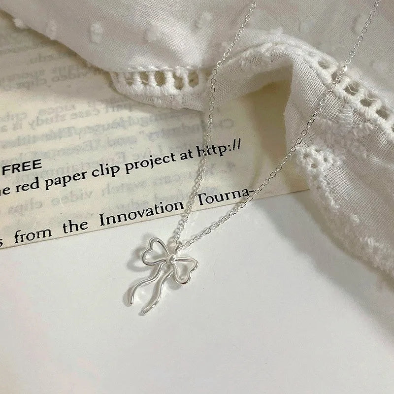 Close-up of the pendant and clasp on the Simple Bow Necklace