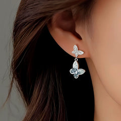 Model showcasing the dangle and style of the Sterling Silver Diamond Butterfly Earrings