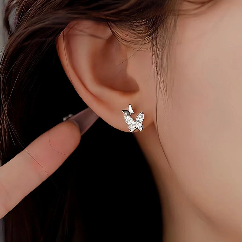 Model showcasing the dangle and style of the Sterling Silver Diamond Double-Butterfly Earrings