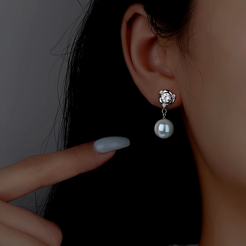 Model showcasing the dangle and style of the Sterling Silver Diamond Pearl Earrings