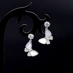 Model showcasing the dangle and style of the Sterling Silver Diamond Shell Butterfly Earrings