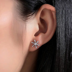 Model showcasing the dangle and style of the Sterling Silver Christmas Diamond Snowflake Stud Earrings