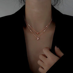 Sterling Silver Double-Layer Star And Moon Necklace worn to showcase its length and pendant detail