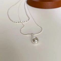 Close-up of the pendant and clasp on the Butterfly Pearl Earrings