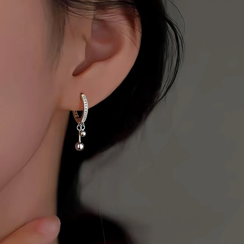 Model showcasing the dangle and style of the Sterling Silver Double Ball Earrings