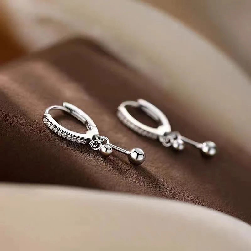 Close-up detail of the sparkling zircons and plating on the Tassel Earrings