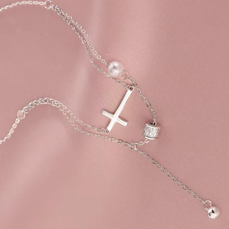 Detailed view of the Sterling Silver Double Layer Stacked Cross Pearl Necklaces chain and pendant
