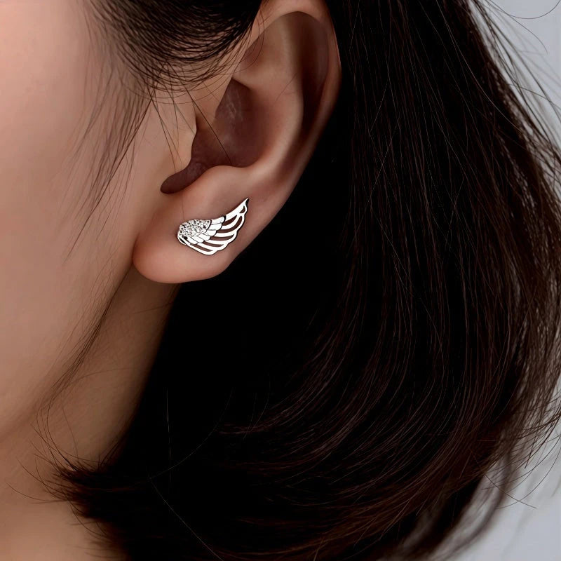 Model showcasing the dangle and style of the Sterling Silver Elegant Angel Wing Crawler Earrings