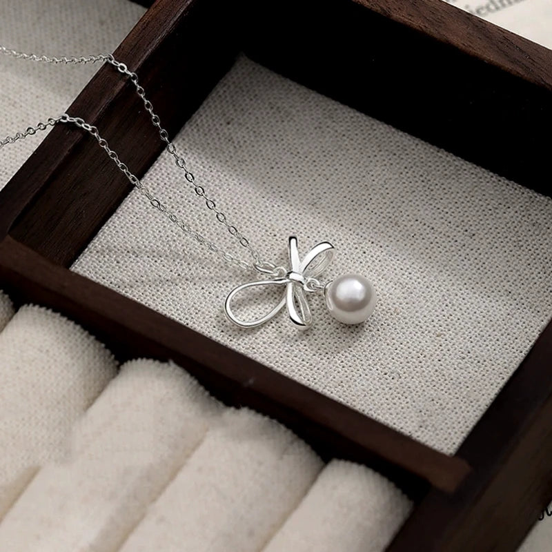 Detailed view of the Sterling Silver Elegant Bow Pearl Necklace chain and pendant