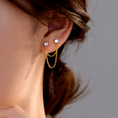 Model showcasing the dangle and style of the Sterling Silver Elegant Cat's Eye Stone Chain Tassel Earrings