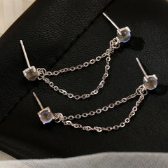 Angled view of the Sterling Silver Elegant Cat's Eye Stone Chain Tassel Earrings
