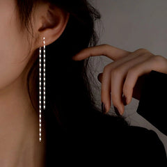 Model showcasing the dangle and style of the Sterling Silver Elegant Chain Tassel Earrings