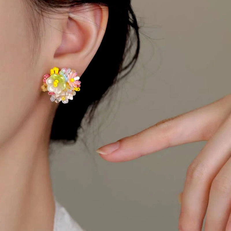 Model showcasing the dangle and style of the Sterling Silver Elegant Dopamine Flower Stud Earrings