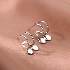 Model showcasing the dangle and style of the Sterling Silver Elegant Double-Layer Heart Earrings
