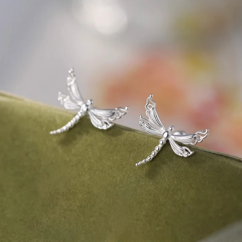 Model showcasing the dangle and style of the Sterling Silver Elegant Dragonfly Stud Earrings