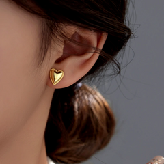 Model showcasing the dangle and style of the Sterling Silver Elegant Heart Studs