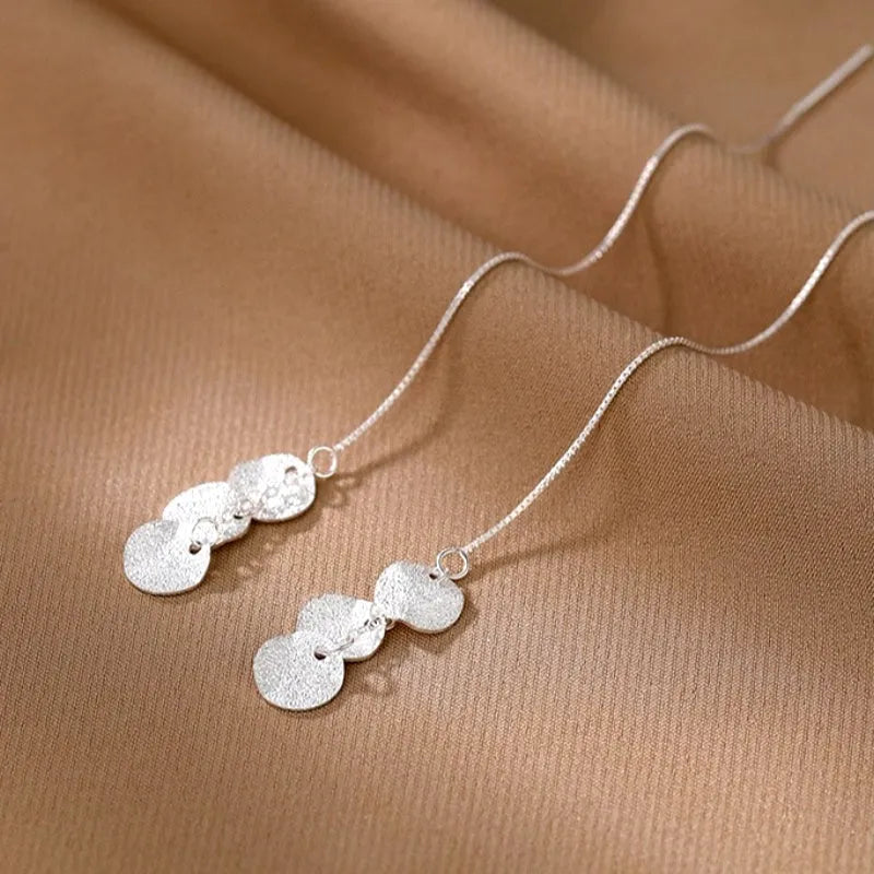 Close-up detail of the sparkling zircons and plating on the Heart Tassel Earrings