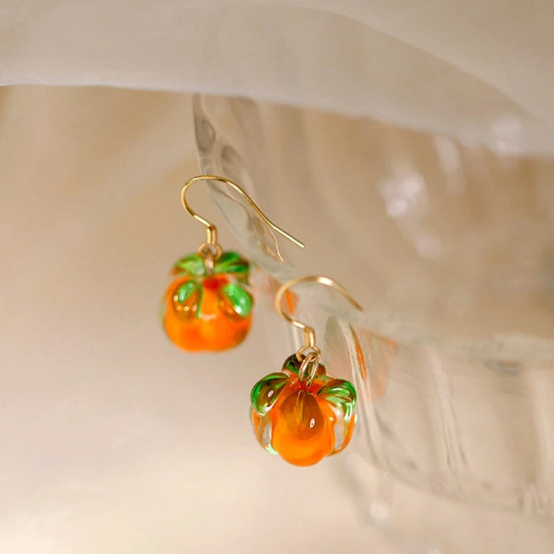 Model showcasing the dangle and style of the Sterling Silver Elegant Persimmon Ruyi Ear Hook Earrings