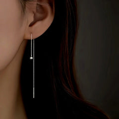 Model showcasing the dangle and style of the Sterling Silver Elegant Round Bead Long Threader Earrings