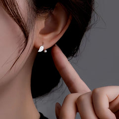 Model showcasing the dangle and style of the Sterling Silver Elegant Screw Leaf Earrings